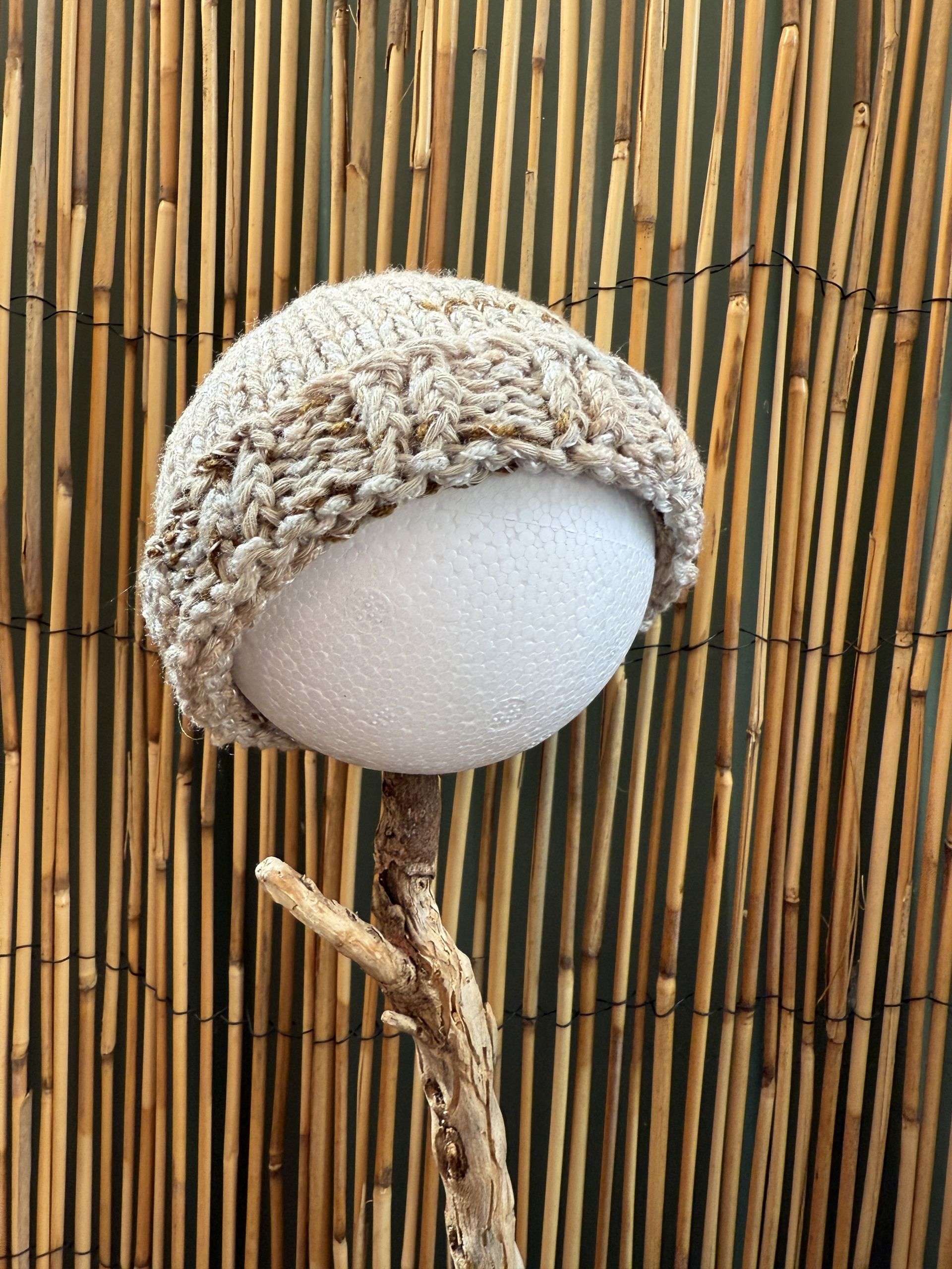 An oatmeal baby beanie handmade with a pretty cable texture, cosy enough for premmies and newborns alike.