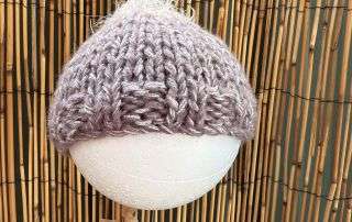 Our fluffy top baby beanie handmade in soft lilac, a little bit of whimsy for a little person.