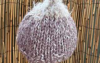 Our fluffy top baby beanie handmade in soft lilac, a little bit of whimsy for a little person.