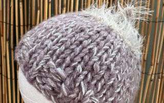 Our fluffy top baby beanie handmade in soft lilac, a little bit of whimsy for a little person.