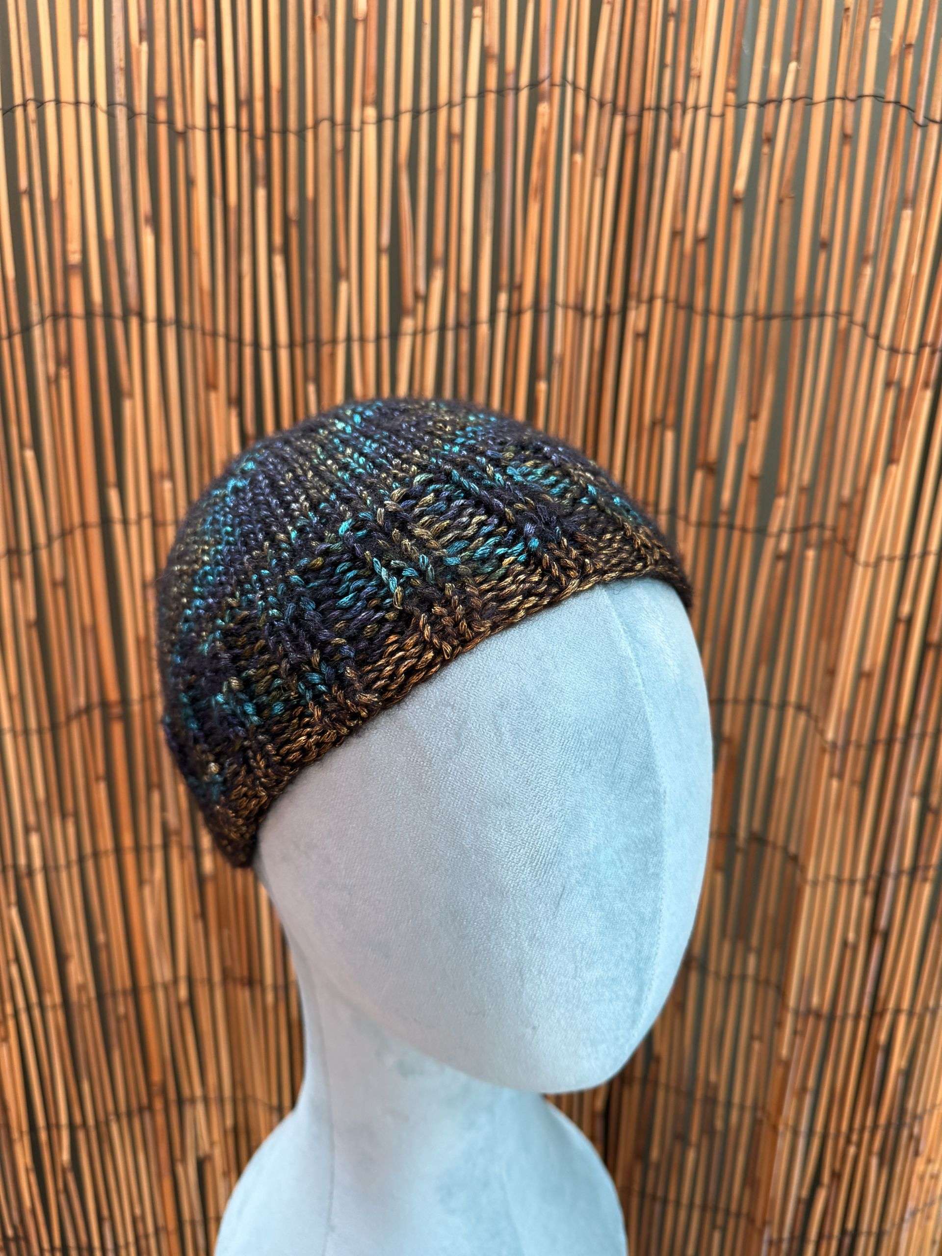 Midnight blue flecked with gold, this handknitted beanie is one of our moodiest adult beanies yet.