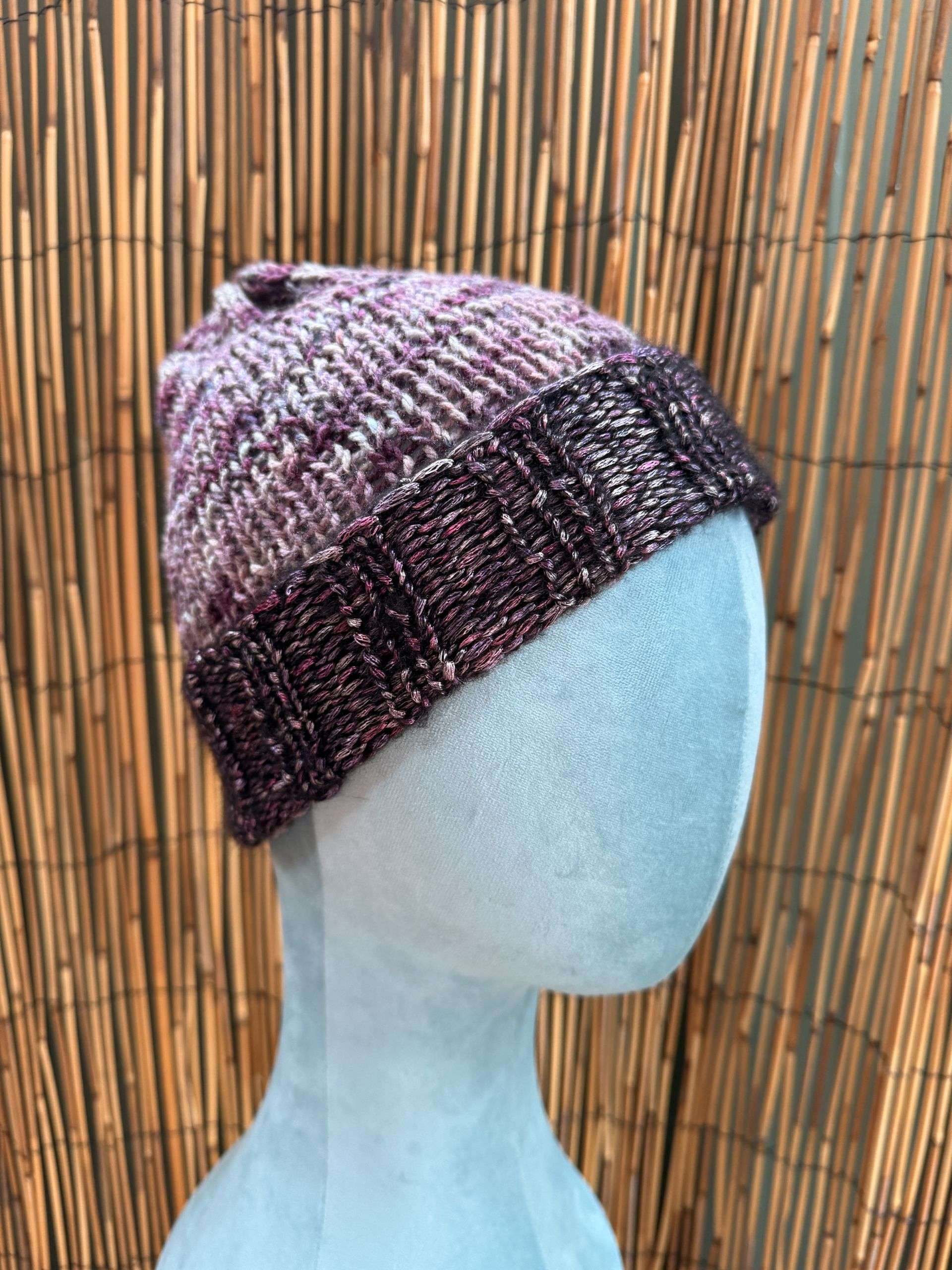 A dreamy plum marl adult beanie, handknitted stitch by stitch for cold mornings that need a bit of magic.