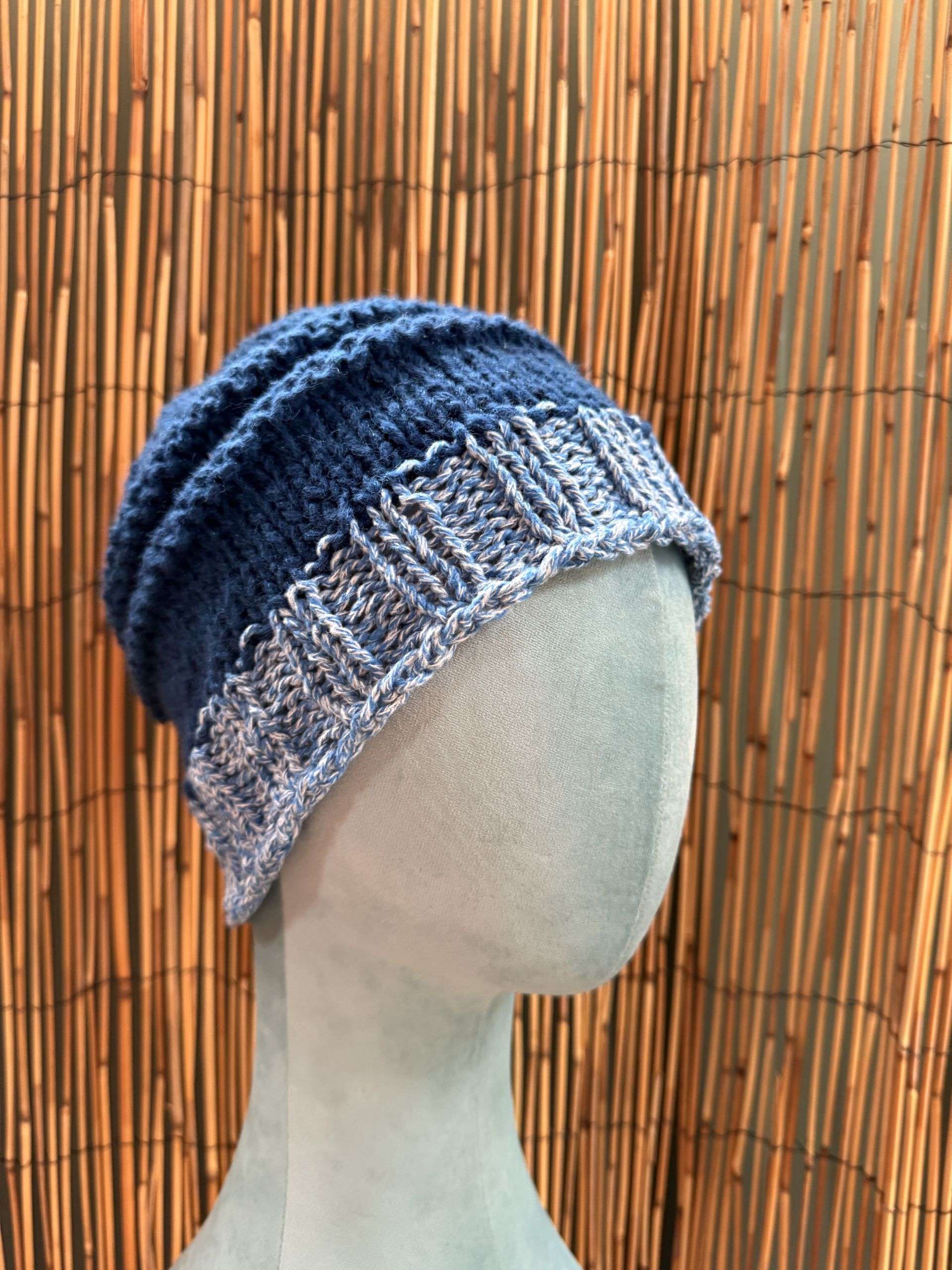 Close up of the blue and white panels on this handmade knitwear beanie, crisp as a winter sky.