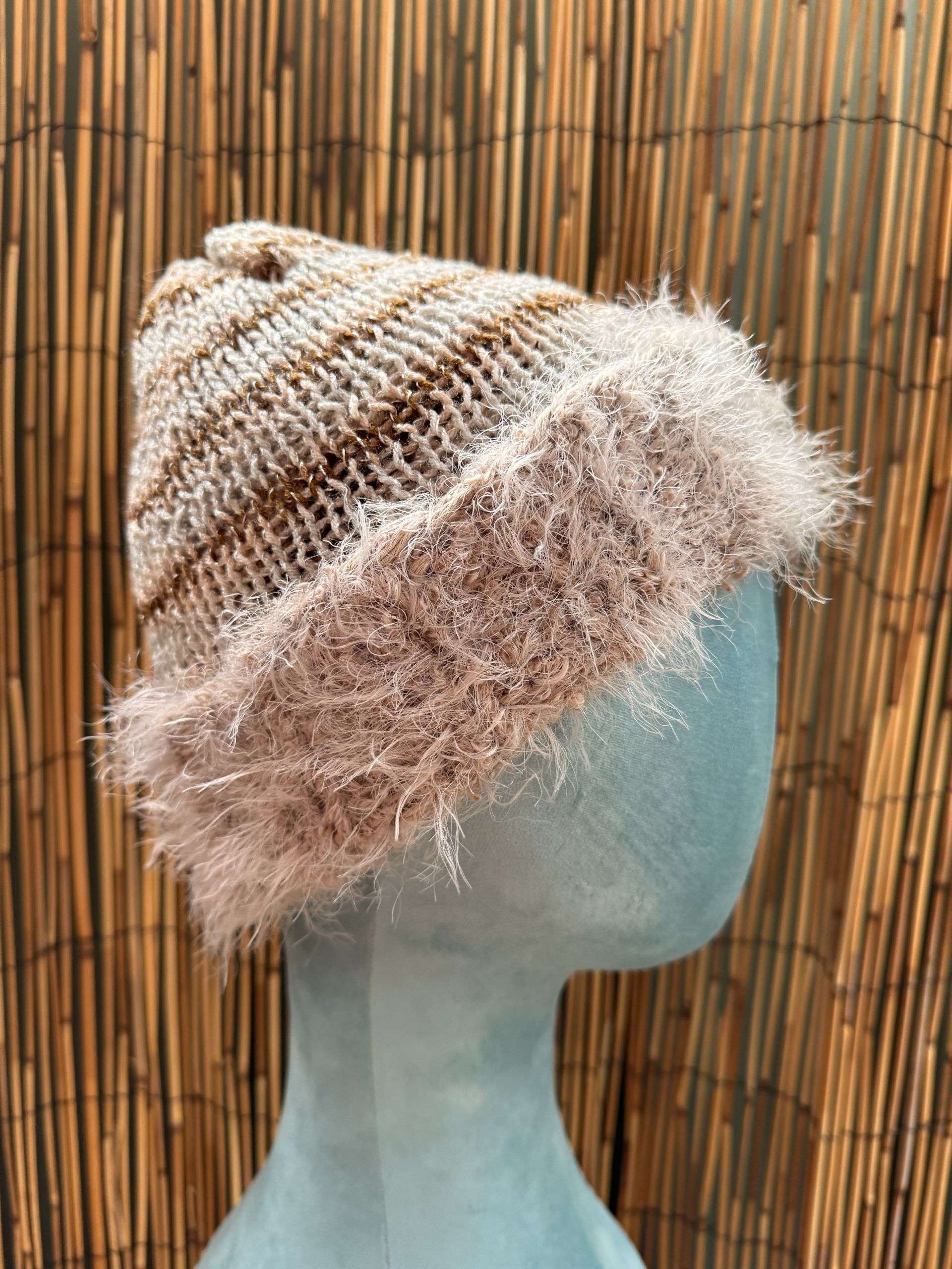 A creamy handknitted beanie with a fluffy contrast brim, one of our cosiest adult beanies for winter walks.