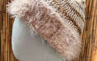 Close up of the fuzzy trim on this handmade knitwear beanie, soft as a cloud and just as dreamy.
