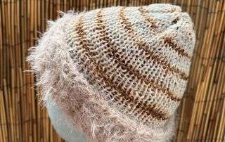 Our creamy adult beanie styled and ready for its next chilly adventure, handknitted with love by Pixel Witch Designs.
