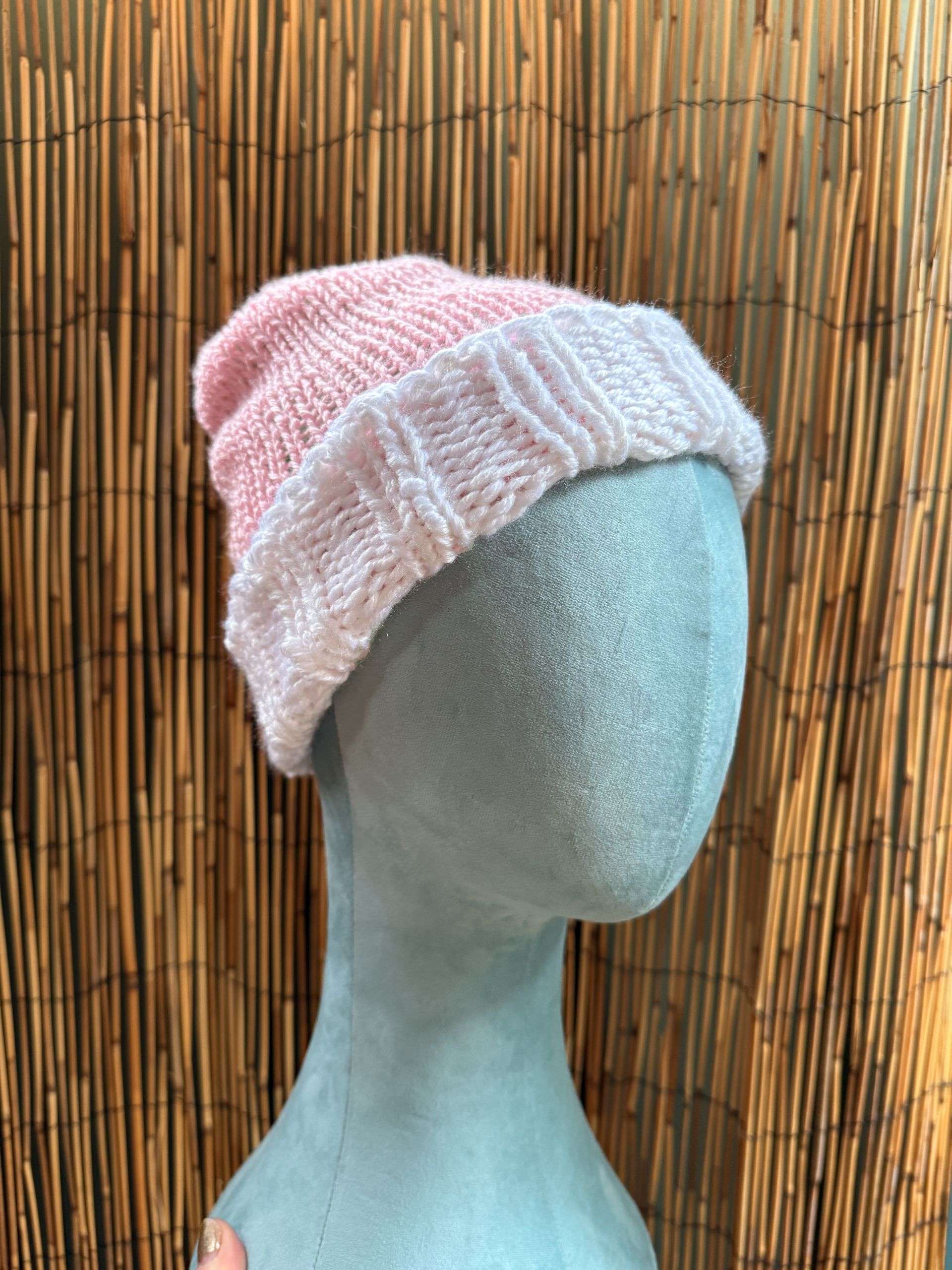 Pretty in pink, this reversible handknitted beanie flips to reveal a fresh green side for double the styling fun.